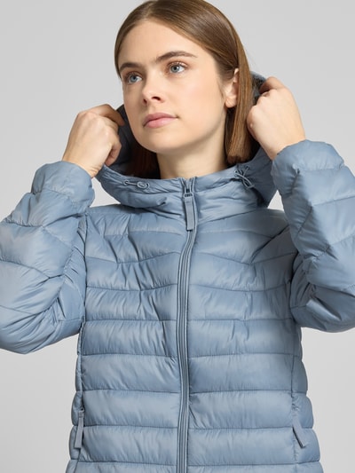 Frauenmodel trägt Regular Fit Steppjacke mit Kapuze Modell 'TAHIA' von Only, unifarben, Reißverschluss, Nahaufnahme Oberkörper.