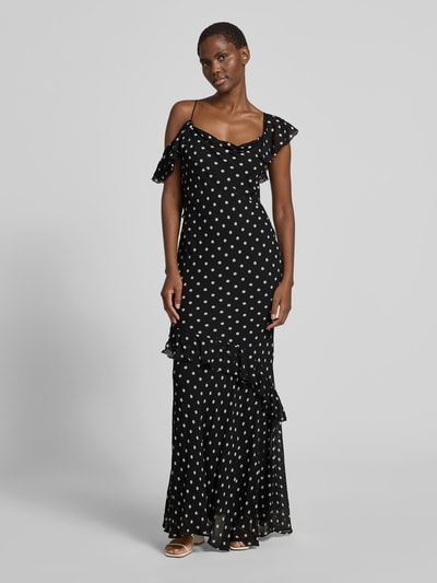 Frauenmodel trägt Maxikleid aus reiner Viskose von Self-Portrait, schwarz mit weißen Punkten, asymmetrisch, ärmellos, figurbetont, Ganzkörperansicht von vorne.