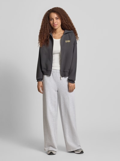 Frauenmodel trägt Oversized Sweatjacke mit Kapuze Modell 'Admira' von LeGer by Lena Gercke aus Baumwoll-Mix, anthrazit, Reißverschluss, lockere Passform, Ganzkörperansicht von vorne.