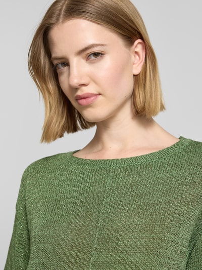 Frauenmodel trägt Relaxed Fit Pullover mit U-Boot-Ausschnitt von s.Oliver BLACK LABEL, schimmernde Optik, Strick, Label-Patch, Nahaufnahme Oberkörper.