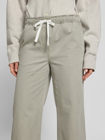 Frauenmodel trägt Wide Fit Jeans mit Tunnelzug von Juvia in Hellgrau, reine Baumwolle, Eingrifftaschen, Nahaufnahme Oberkörper.