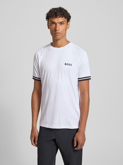 Männermodel trägt Regular Fit T-Shirt mit Label Print Modell 'TOC SERVE 2' von BOSS Green, Optik: Unifarben, Allover-Muster, Logo-Print, Kontraststreifen, Rundhals, Kurzarm, elastisch, Stretch, Ganzkörperansicht von vorne.