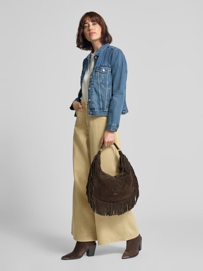Frauenmodel trägt Handtasche aus Leder mit Fransen Modell 'NANA' von Abro, dunkelbraun, Tragehenkel, Fransendetail, Ganzkörperansicht von vorne.