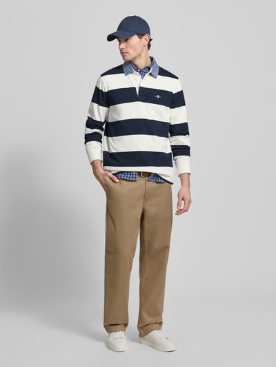 Männermodel trägt Sweatshirt mit Label-Stitching von Gant in Dunkelblau und Weiß, Polokragen, Regular Fit, Ganzkörperansicht von vorne.