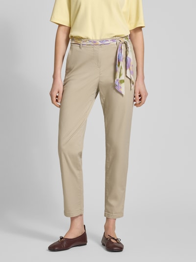 Frauenmodel trägt Slim Fit Chino mit Viskose-Anteil von Christian Berg Woman in Beige mit abnehmbarem Stoffband, Verkürzte Passform, Nahaufnahme Oberkörper.