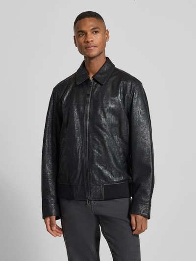 Männermodel trägt Regular Fit Lederjacke mit Allover-Muster Modell 'JUZE_CNY' von BOSS aus schwarzem Lammleder, strukturierte Oberfläche, Optik: Unifarben, Umlegekragen, Zweiwege-Reißverschluss, seitliche Eingrifftaschen, Langarm mit Manschetten, Ganzkörperansicht von vorne.