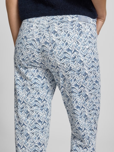 Vrouwenmodel draagt 6/8-broek in 5-pocketmodel model 'Pamina' van Raphaela By Brax, katoenmix met stretch, verkorte pasvorm, elastische band, blauw-wit bladmotief, detailopname achterkant.