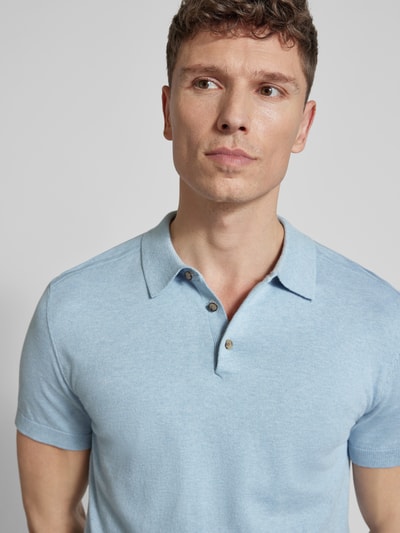 Männermodel trägt Regular Fit Poloshirt aus Bio-Baumwoll-Mix Modell 'BERG' von SELECTED HOMME in Melange-Optik, Nahaufnahme Oberkörper.