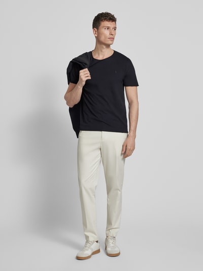Männermodel trägt Regular Fit T-Shirt aus reiner Bio-Baumwolle Modell 'JAAMES' von Armedangels, unifarben, Ganzkörperansicht von vorne.