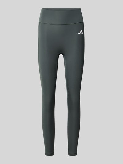 Produktfoto, Eng anliegende Sport-Leggings mit Gesäßtasche von adidas Training in Dunkelgrau mit glatter Struktur, neutraler Hintergrund.