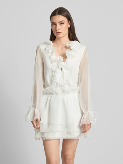 Frauenmodel trägt Minikleid mit Rüschen und Schnürung von Gina Tricot, A-Linie, Semitransparent, Rüschen, Ganzkörperansicht von vorne.