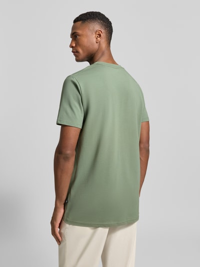 Mężczyzna nosi T-Shirt mit Label-Print Modell 'Jeramy' od Matinique, prosty krój, bawełna z elastanem, kolor zielony, z tyłu, widok całej sylwetki.