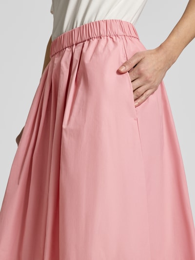 Vrouwenmodel draagt Midirok met elastische band van Christian Berg Woman Selection, materiaalmix met katoen, a-lijn, plooien, detailopname.