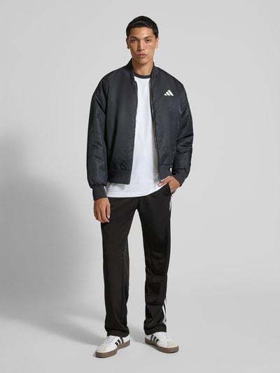 adidas Originals Spodnie treningowe z kieszeniami zapinanymi na zamek błyskawiczny model ‘FIREBIRD’ Czarny 1