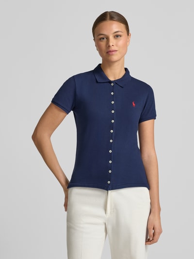 Frauenmodel trägt Poloshirt mit Knopfleiste von Polo Ralph Lauren im Slim-Fit aus Baumwoll-Elasthan-Mix mit Hemdblusenkragen und Label-Stitching, navyblau mit weißen Knöpfen, Rückenlänge bei Größe S: 55 cm, Ganzkörperansicht von vorne.