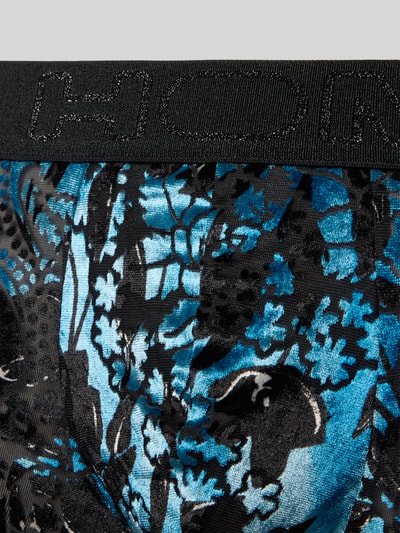 Produktfoto, Slim Fit Trunk mit floralem Allover-Print Modell 'Fremont' von HOM im semitransparenten Elastischer-Material-Mix, Logo-Detail am Bund