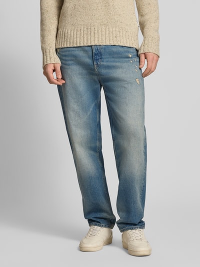Männermodel trägt Tapered Fit Jeans aus reiner Baumwolle Modell 'SONNY' von Tommy Jeans in Denim-Optik, Used-Look, Ganzkörperansicht von vorne.