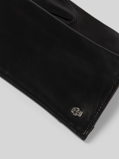 Produktfoto, schwarze Handschuhe aus echtem Leder Modell 'HAMBURG' von Roeckl, Woll-Kaschmir-Mix Innenfutter, Label-Detail, eingefasste Abschlüsse