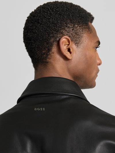 Männermodel trägt Regular Fit Lederjacke Modell 'JOBAN' von BOSS Orange in schwarzer Lederoptik, Material Echtleder, Nahaufnahme Rücken.