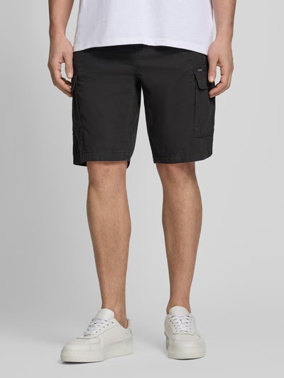 Mężczyzna nosi Regular Fit Bermudas mit Cargo-Taschen von Petrol, czarne bermudy z bawełny, szerokość w rozmiarze M: 45 cm, długość wewnętrzna nogawki: 27 cm, kieszenie cargo i kieszeń z tyłu, krój regular fit, przód, pełny widok ciała