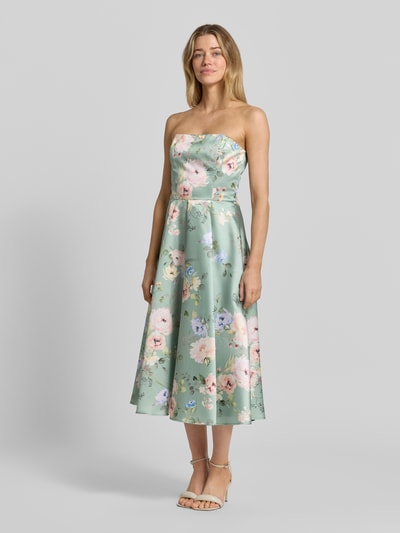 Kobieta modelka nosi sukienkę koktajlową im Off-Shoulder-Look od Swing, taliowany krój, sukienka midi, pastelowe kwiaty, tylny zamek błyskawiczny, długość tyłu w rozmiarze 36: 98 cm, szerokość klatki piersiowej w rozmiarze 36: 41 cm, widok całej sylwetki z przodu.