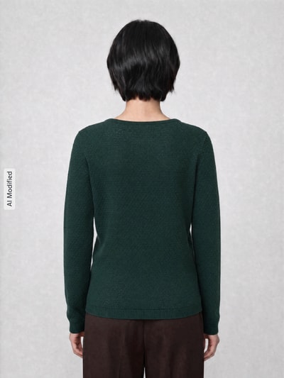 Kobiece model prezentuje Regular Fit Pullover aus reiner Baumwolle Modell 'CARE' od VERO MODA, ciemnozielony, tekstura dzianiny, widok całej sylwetki z tyłu, obraz zmodyfikowany przez AI.