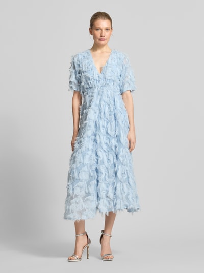 Frauenmodel trägt hellblaues Cocktailkleid mit Fransen Modell 'PAZYLLA' von YAS, A-Linie, V-Ausschnitt, Midikleid, Ganzkörperansicht von vorne. Rückenlänge bei Größe 36: 125 cm, Brustweite bei Größe 36: 43 cm, Ärmellänge bei Größe 36: 28 cm.