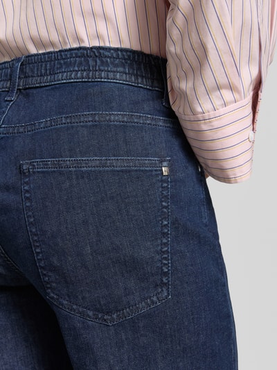 Frauenmodel trägt Cropped Straight Leg Jeans aus Baumwoll-Mix von Brax in dunkler Denim-Optik mit 5-Pocket-Design, Detailaufnahme Rückansicht.