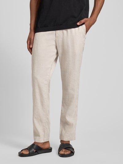 Männermodel trägt Regular Fit Leinenhose aus Leinen-Mix Modell 'SANDERSON' von BOSS Orange in Beige, Flammgarntextur, Nahaufnahme Unterkörperansicht.