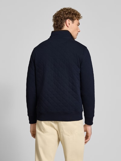 Männermodel trägt Regular Fit Troyer aus Baumwoll-Mix von GANT, jednokolorowy, krój regular fit, faktura, naszywka z logo, stójka, wysoki dekolt, długi rękaw, prążkowane zakończenia, dzianina dresowa, mieszanka bawełny, Ganzkörperansicht Rückansicht