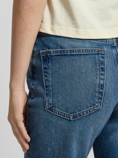 Frauenmodel trägt Straight Fit Jeans mit Logo-Patch von Calvin Klein Jeans, mittelblaue Denimstruktur, 5-Pocket-Design, Detailaufnahme Rückansicht.