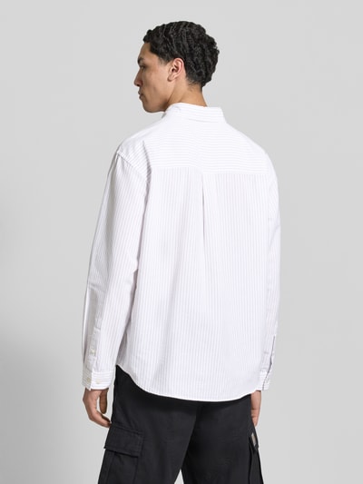 Männermodel trägt weißes Regular Fit Freizeithemd mit feinen Streifen, Brusttasche und Button-Down-Kragen, Modell 'NORREBRO' von Jack & Jones aus Baumwoll-Mix, Ganzkörperansicht Rückansicht.