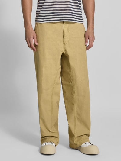Männermodel trägt Straight Fit Hose aus reiner Baumwolle von Diesel in Beige, sichtbare Gürtelschlaufen und Gesäßtaschen, Nahaufnahme Oberkörper bis Schuhe, reine Baumwolle, Knopf- und Reißverschluss, Bundweite 44 cm, Innenbeinlänge 78 cm.