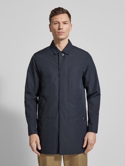 Męski model nosi Kurzmantel mit verdeckter Knopfleiste Modell 'miles' od Matinique, kolor granatowy, krój regular fit, z kołnierzem wykładanym, Szerokość w rozmiarze M: 55 cm, długość pleców: 88 cm, długość rękawa: 66 cm, Szerokość w ramionach: 45 cm, widok całej sylwetki z przodu.