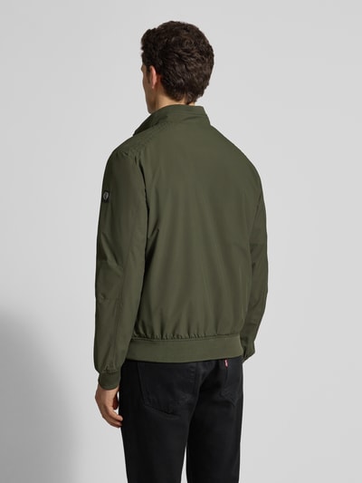 Männermodel trägt Regular Fit Jacke mit Stehkragen von Lerros in Olivgrün, elastischer Material-Mix, Logo-Detail, Rückenansicht Ganzkörperansicht.