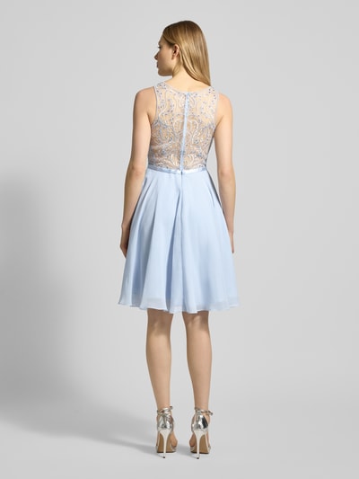 Vrouwenmodel draagt Cocktailjurk met strass-steentjes van Luxuar, effen design lichtblauw, semi-transparant, ritssluiting, getailleerd, knielengte, ruglengte maat 36 96 cm, borstwijdte maat 36 41 cm, geheelopname achteraan