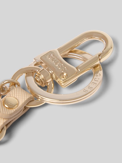 Productfoto, sleutelhanger met logodetail model 'Gilda' van GUESS in goudkleur met leerlook, dames sleutelhanger met sleutelring.
