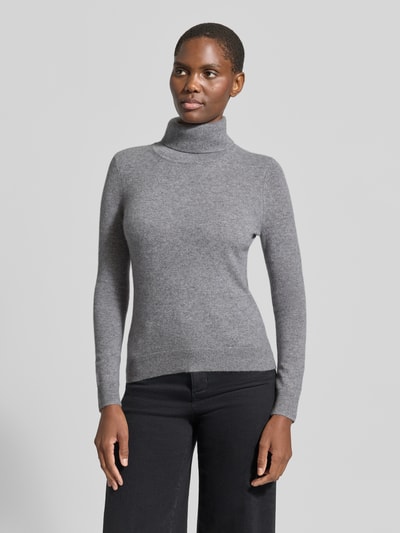 Frauenmodel trägt Regular Fit Rollkragenpullover aus reinem Kaschmir von Christian Berg Woman in Grau, gerippter Kragen, Ganzkörperansicht von vorne.