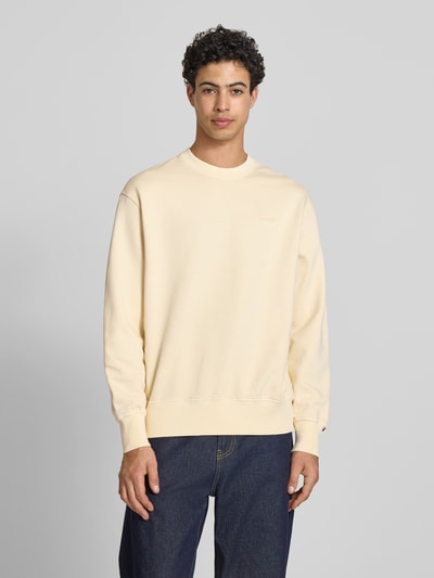 Männermodel trägt Relaxed Fit Sweatshirt aus reiner Baumwolle von Levi's®, unifarben, Rundhals, Label Stitching, Ganzkörperansicht von vorne.