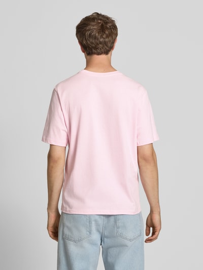 Männermodel trägt T-Shirt mit Label-Patch und Rundhalsausschnitt von REVIEW, Boxy-Fit, Reine Baumwolle, Rückenlänge 66 cm, Ganzkörperansicht Rückansicht.