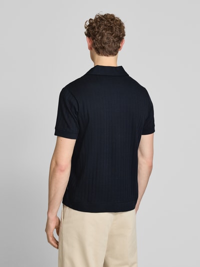 Męski model nosi Regular Fit Poloshirt mit durchgehender Knopfleiste von JOOP! Collection z bawełny, model 'Juanmanuel', kolor czarny, krój regular fit, długość tyłu w rozmiarze M: 72 cm, szerokość w rozmiarze M: 46 cm, długość rękawów w rozmiarze M: 24 cm, struktura prążkowana, widok całej sylwetki z tyłu.