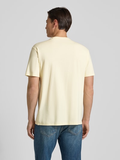 Männermodel trägt T-Shirt mit Logo und Rundhalsausschnitt von Guess aus Baumwoll-Mix mit Modal-Anteil, Relaxed-Fit, Rückenlänge 73 cm, Ganzkörperansicht Rückansicht.