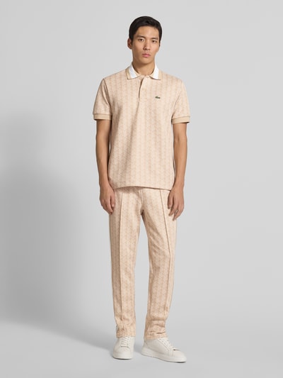 Männermodel trägt Regular Fit Poloshirt mit Baumwoll-Anteil von Lacoste, Optik: Unifarben, Allover-Muster, Ganzkörperansicht von vorne.