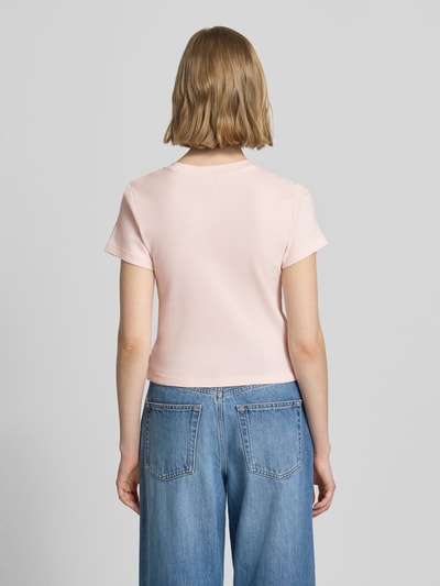 Frauenmodel trägt Regular Fit T-Shirt aus reiner Baumwolle von Levi's®, unifarben rosa, kurzarm, Rundhals, Ganzkörperansicht Rückansicht.