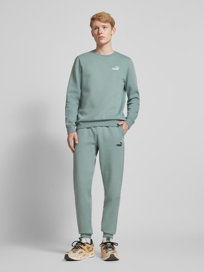 PUMA PERFORMANCE Sweatpants mit Label-Stitching Lind 1