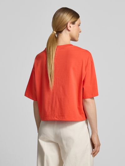 Frauenmodel trägt Boxy Fit T-Shirt mit Perlen und Tunnelzug von Oui in leuchtendem Orange, Baumwoll-Elasthan-Mix, Rückansicht Ganzkörperansicht.