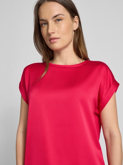 Modelka kobieca ma na sobie T-Shirt z okrągłym dekoltem 'ELLETTE' od Vila z mieszanki wiskozy i elastanu, luźny krój, kolor intensywnie różowy, długość tyłu w rozmiarze 36: 57 cm, zbliżenie na górną część ciała.