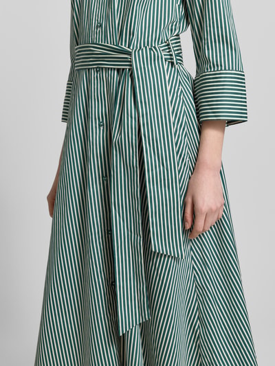Frauenmodel trägt Midikleid mit Hemdblusenkragen von Christian Berg Woman aus Reine Baumwolle, Taillierte Passform, 3/4-Arm, durchgängige Knopfleiste, Abnehmbares Taillenband, grün-weiß gestreift mit glatter Textur, Nahaufnahme Oberkörper.