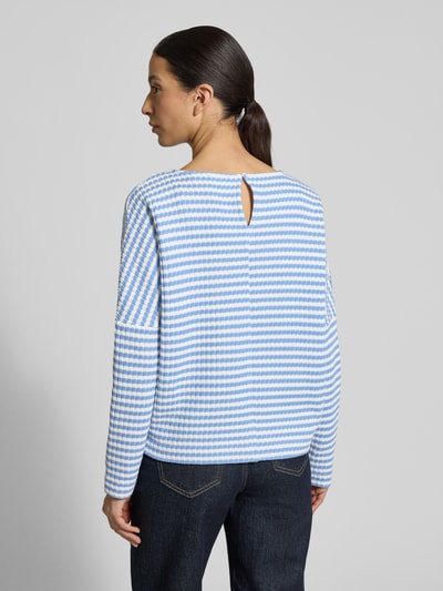 Frauenmodel trägt Relaxed Fit Pullover in Strick-Optik Modell 'Gresh' von OPUS aus reiner Baumwolle, gestreift in Blau und Weiß, Ganzkörperansicht Rückansicht.