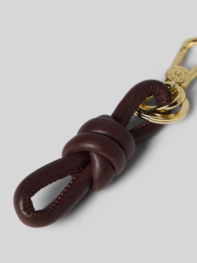 Productfoto, sleutelhanger met knoopdetail van Abro, Karabijnhaak, Label in reliëf, damesaccessoire, bordeauxrood met goud, leerstructuur